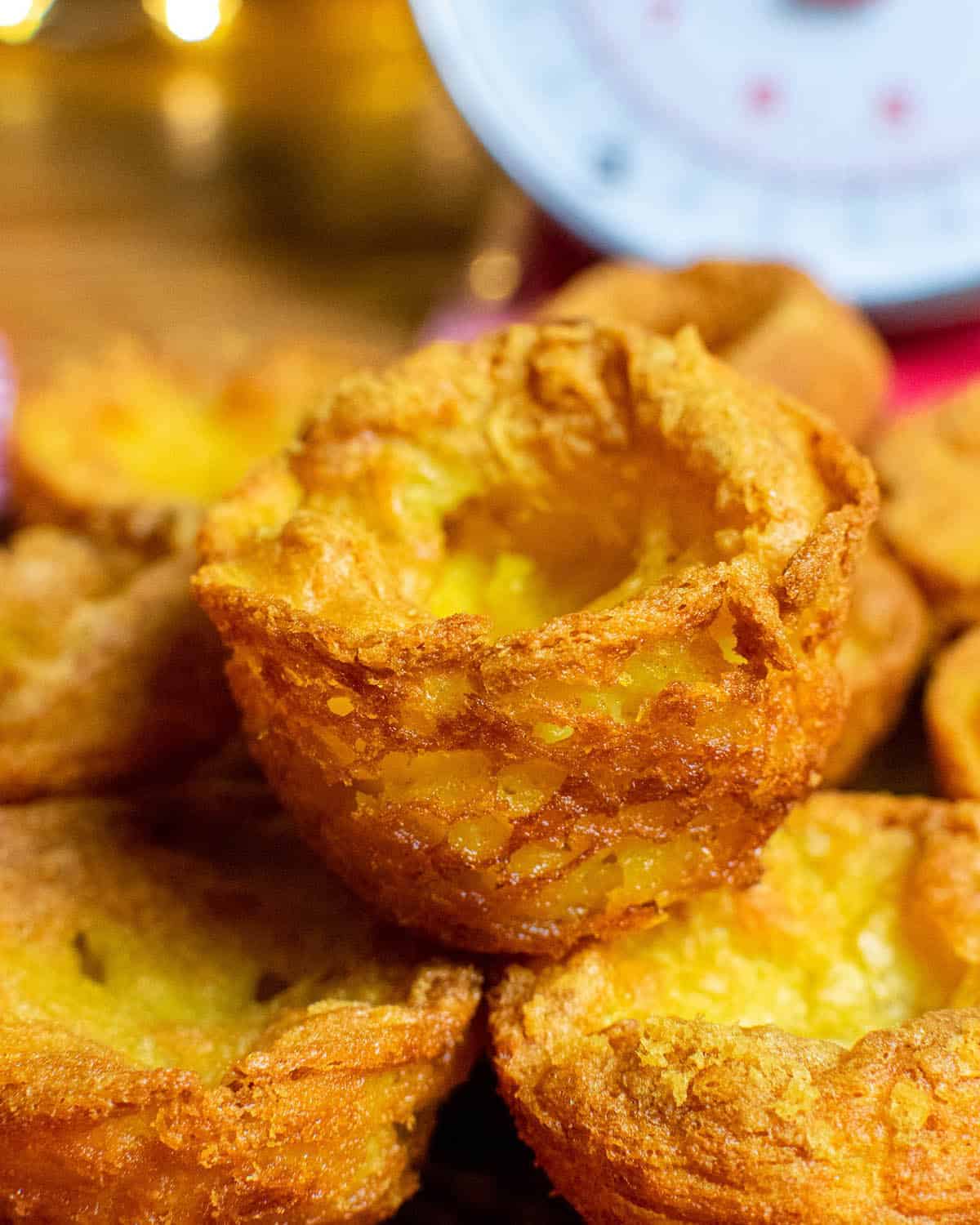 Close up of a pile of vegan yorkshire puddings with scales in the background.