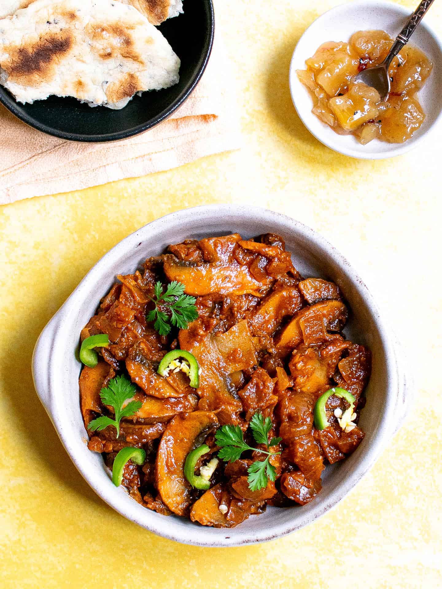 Mushroom bhaji served in a dish with chillies and coriander on top