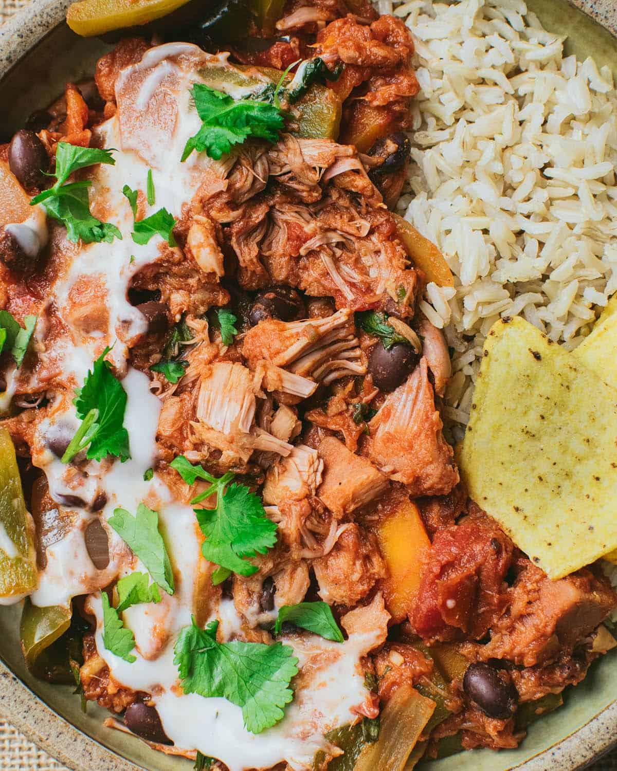 Close up of jackfruit chilli with vegan sour cream and fresh coriander