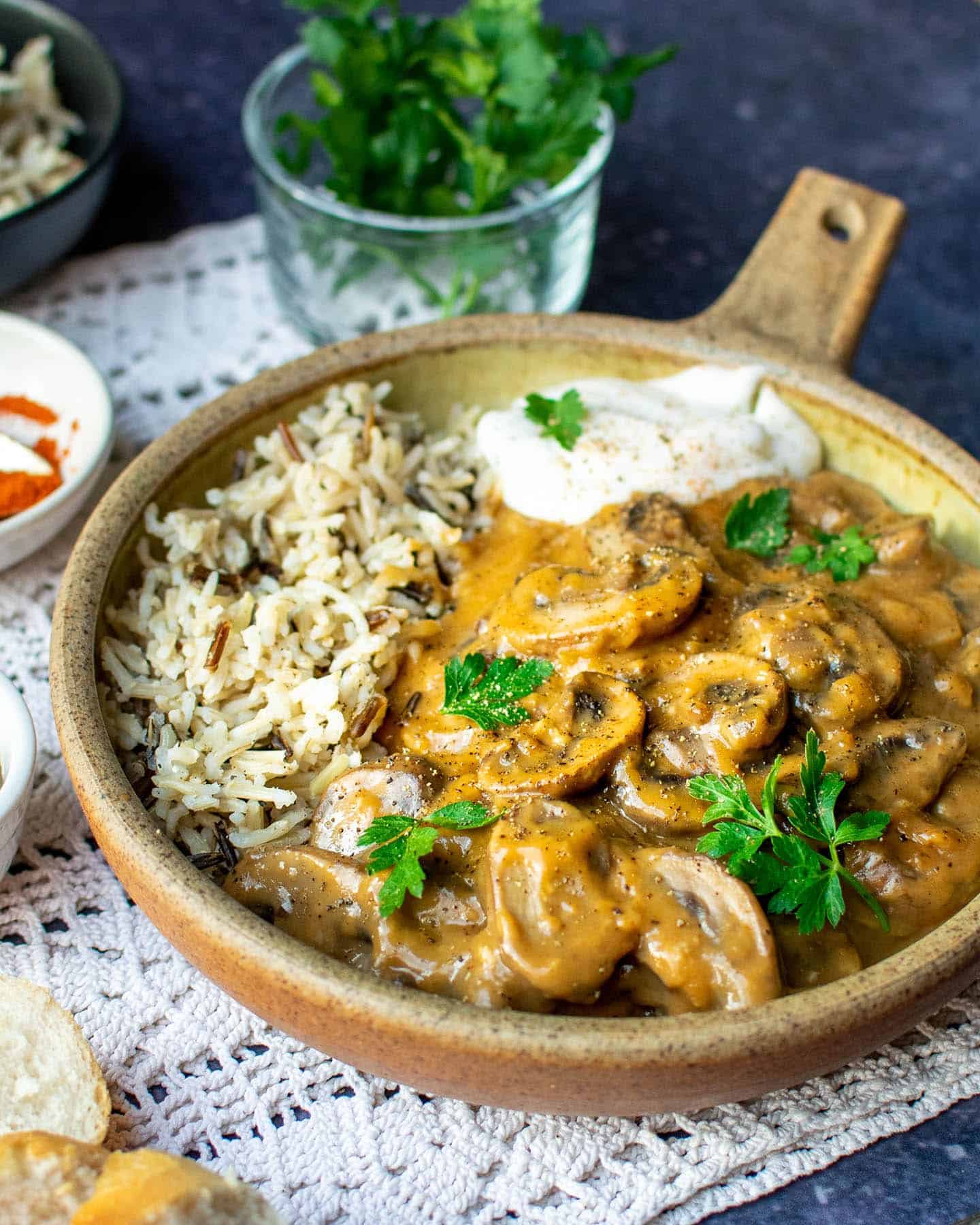 A close-up photo of a bowl of vegan stroganoff. It's a rich, golden brown colour and is filled with mushrooms.