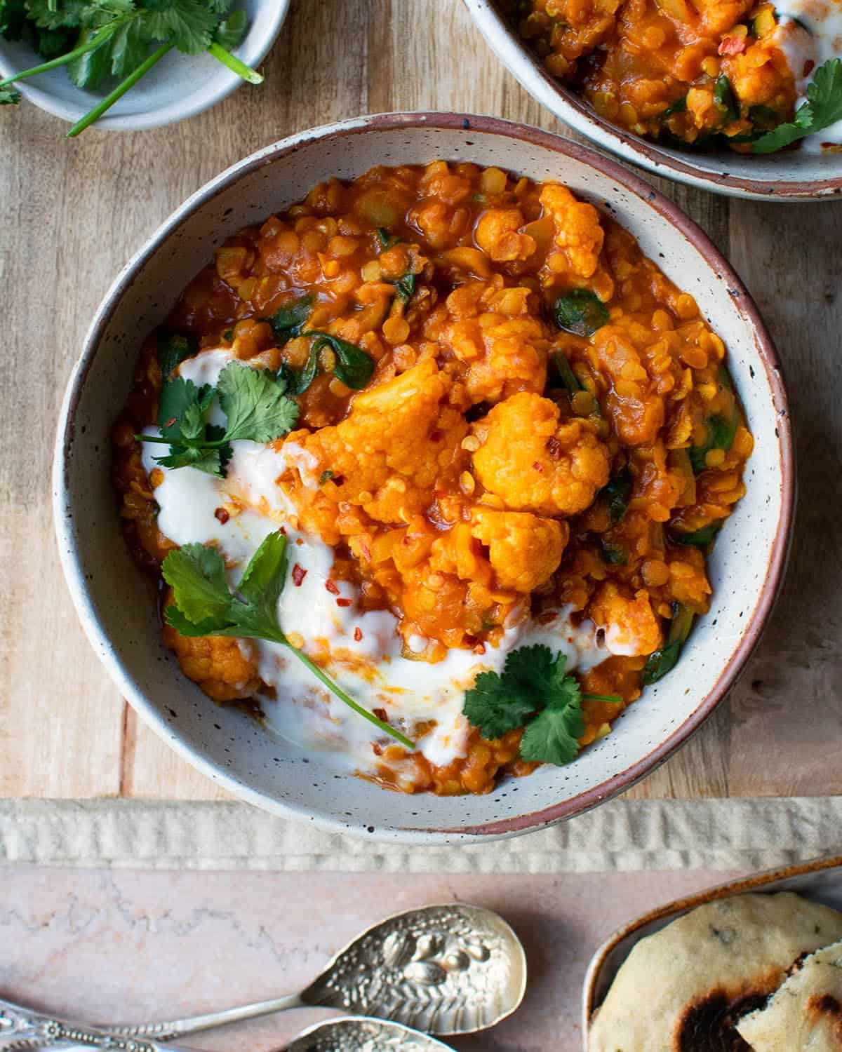 Cauliflower and spinach dal in a bowl with fresh coriander.