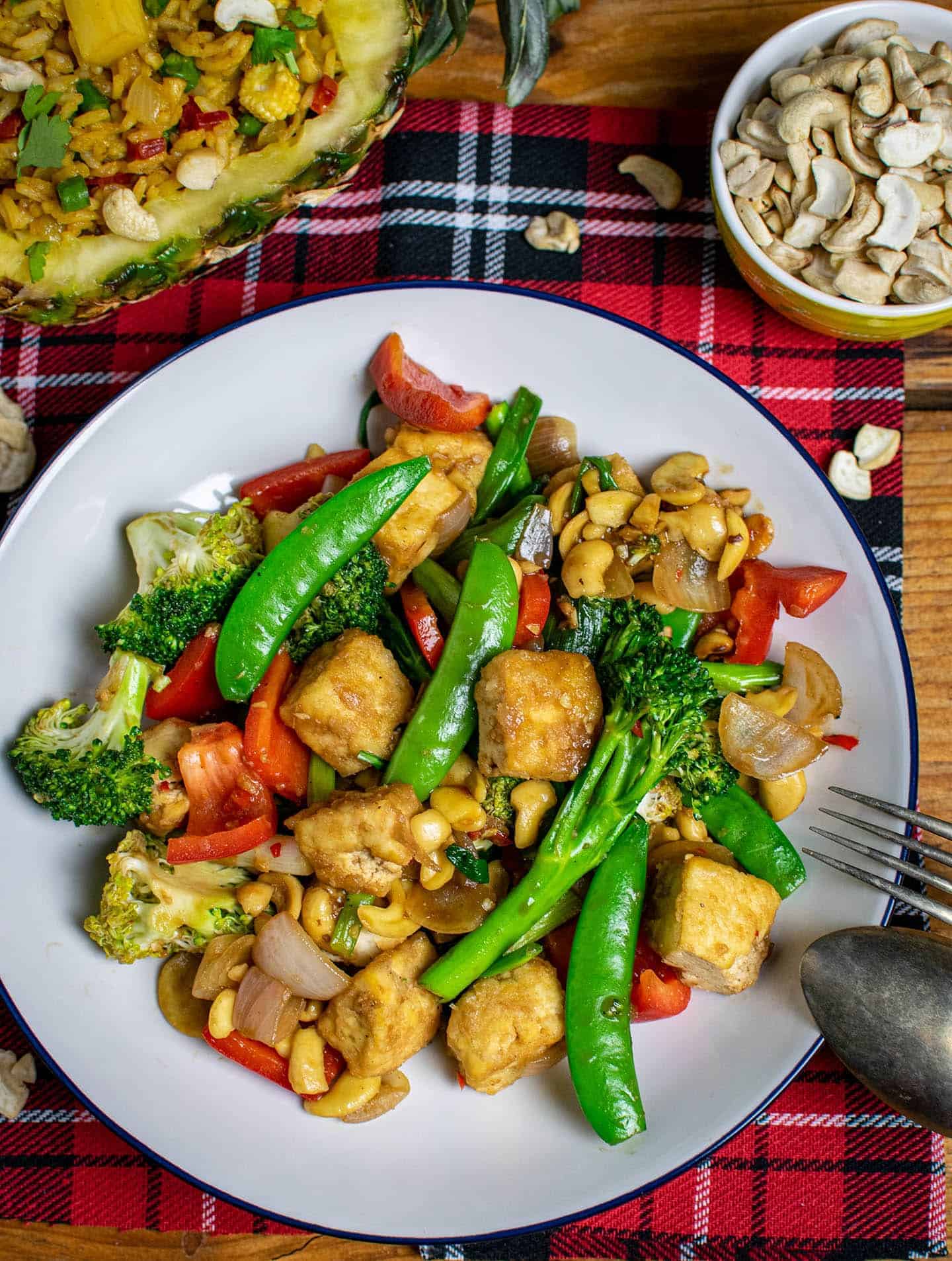 Stir fry on a plate on top of a red background