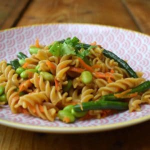 Asian pasta salad on a pink plate