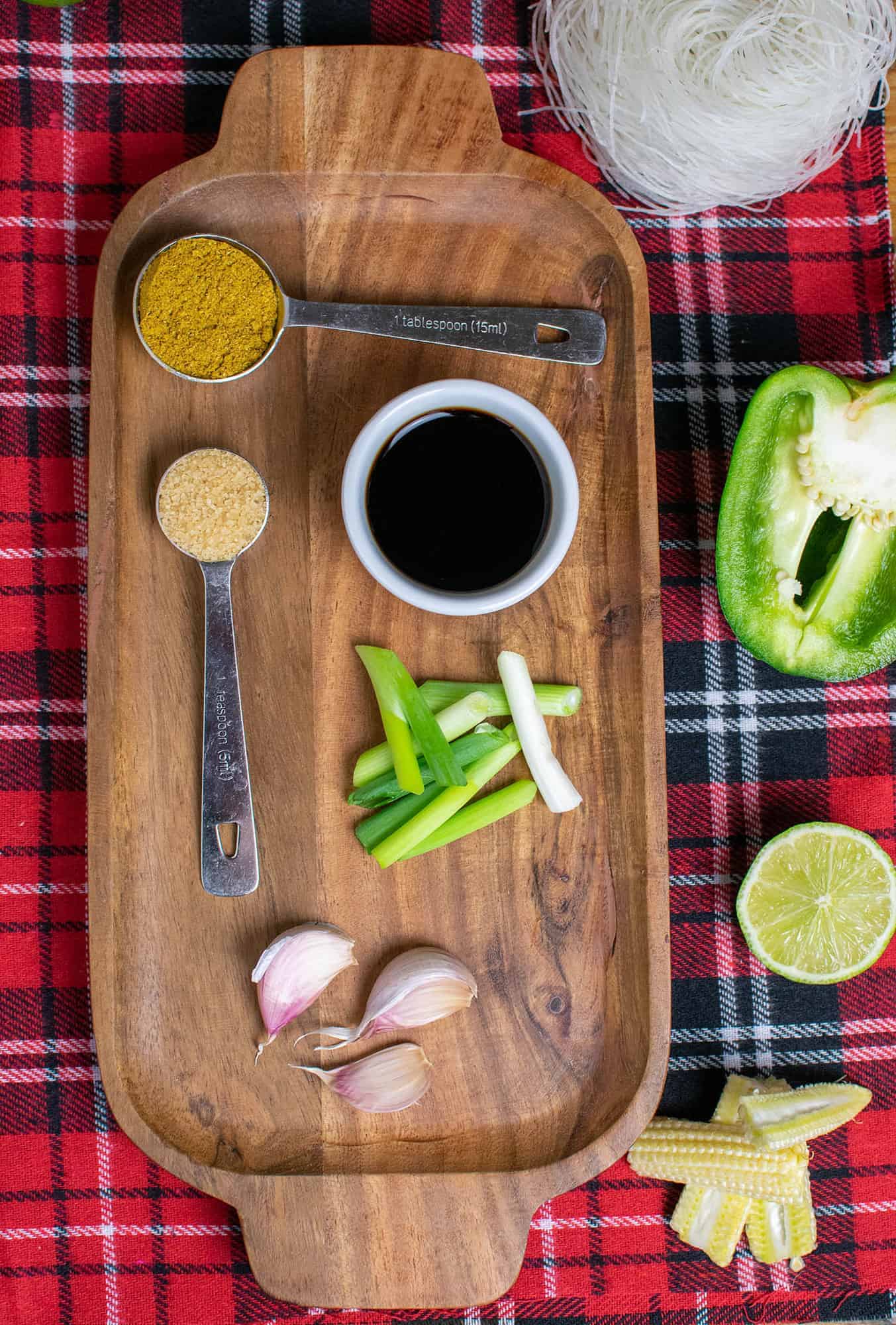Ingredients for this stir fry laid out on a wooden tray.