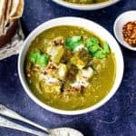 Vegan palak paneer in a bowl on a blue background