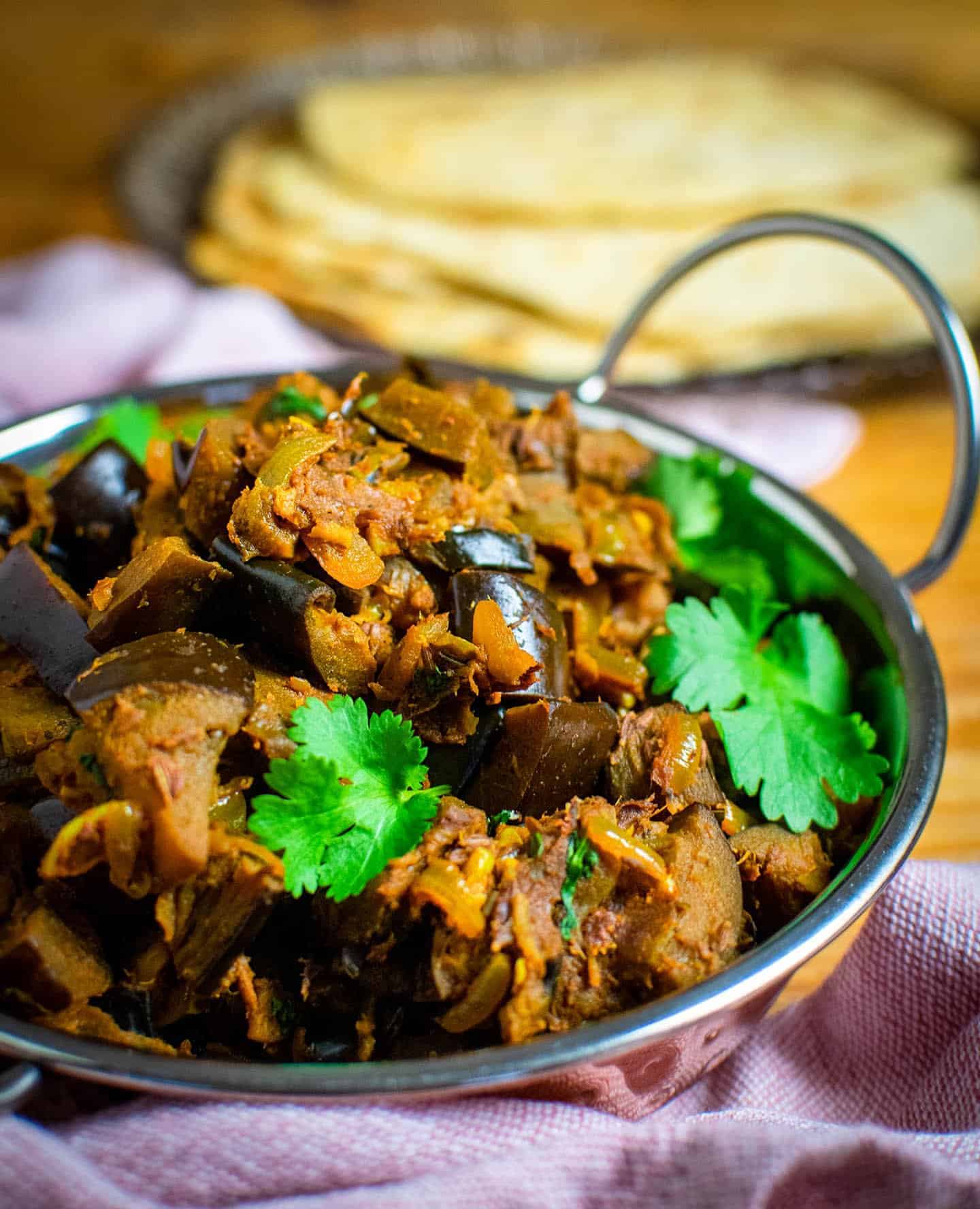 Close up of the dish piled high with food in a balti dish