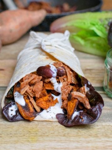 Square image of jackfruit wrap with kidney beans and sweet potato visible.