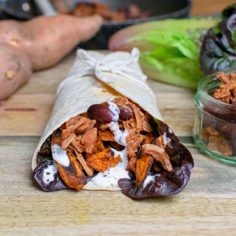 Square image of jackfruit wrap with kidney beans and sweet potato visible.