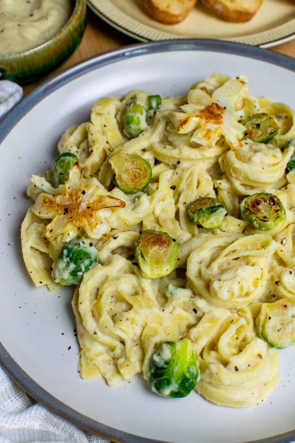 Vegan cauliflower Alfredo on a plate with sprouts