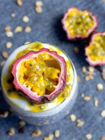Passionfruit chia pudding in a glass with half a passionfruit on top of the pudding