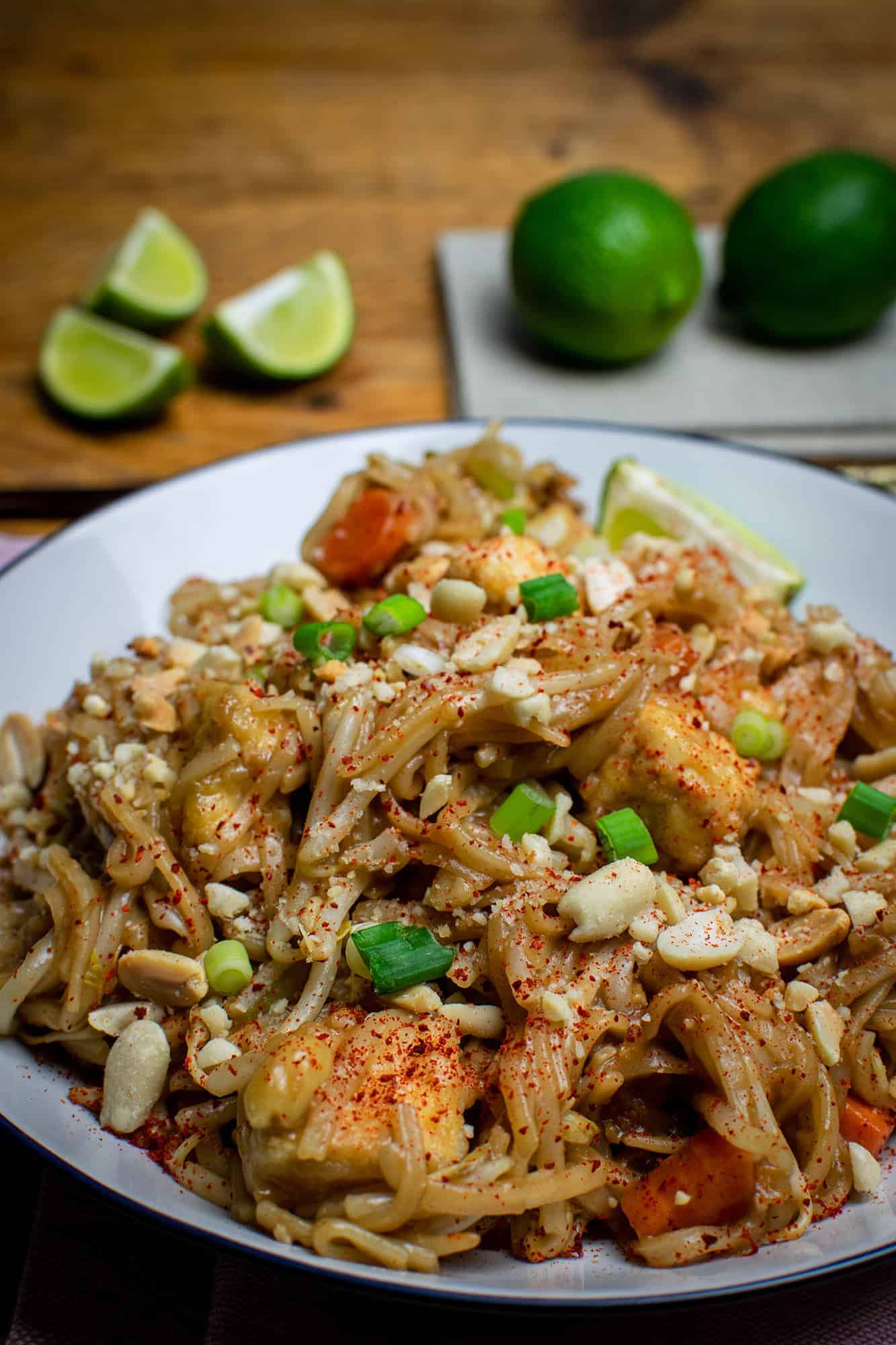 Easy vegan Pad Thai with cut and whole limes in the background