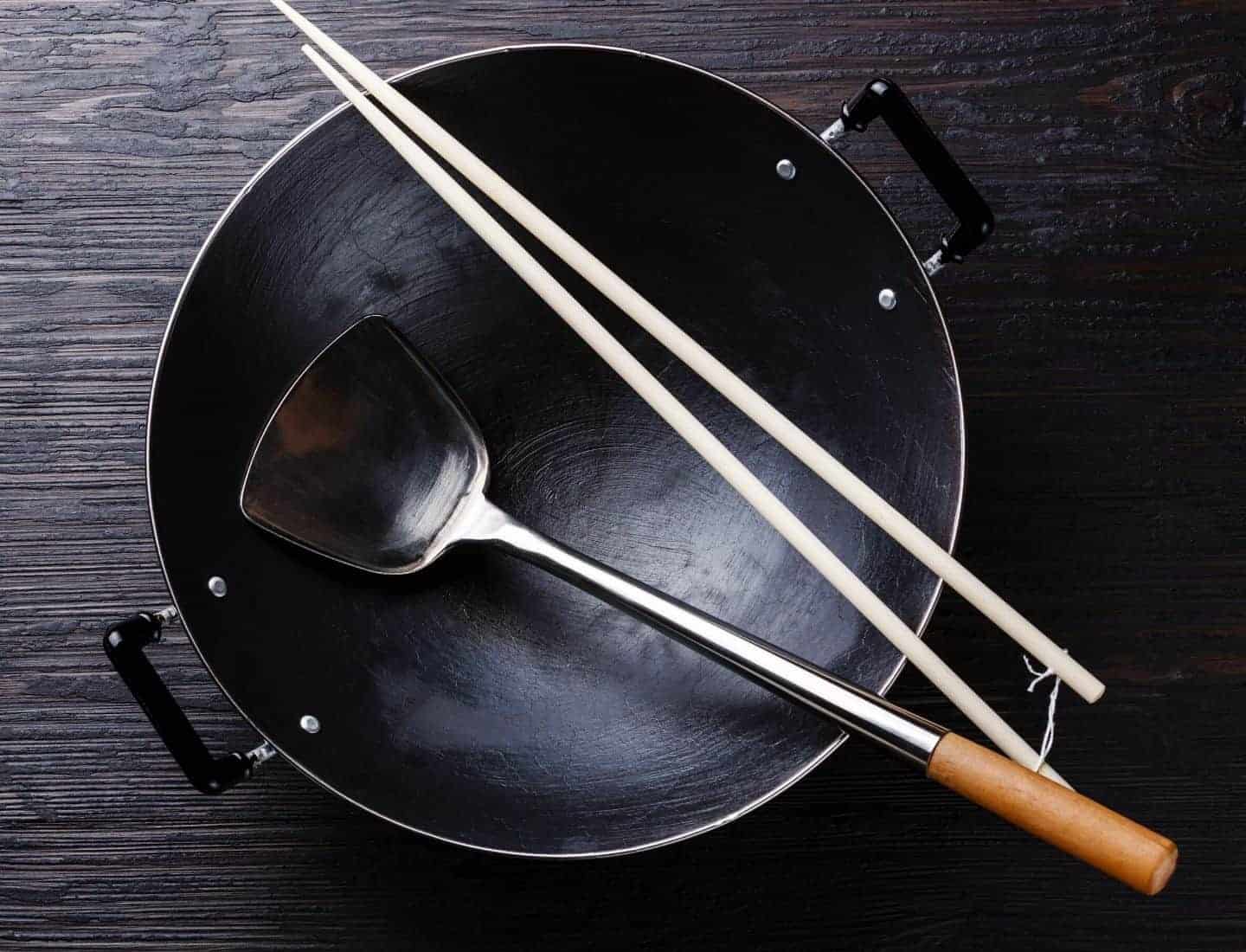 A wok, shovel and chopsticks are all essential Thai cooking utensils
