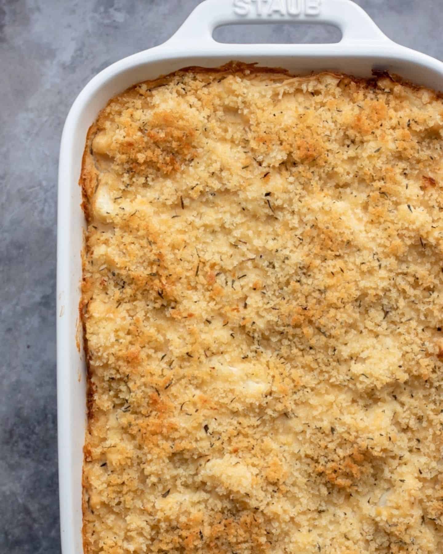 Vegan cauliflower gratin with crumbs topping in a white baking dish