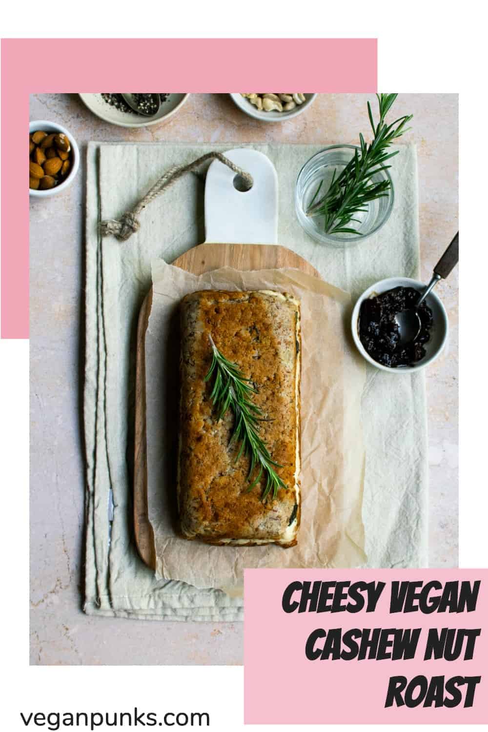 A Pinterest image titled Cheesy Vegan Cashew Nut Roast. The photo in the centre is a top-down shot of a golden brown nut roast with a sprig of thyme laying on top.