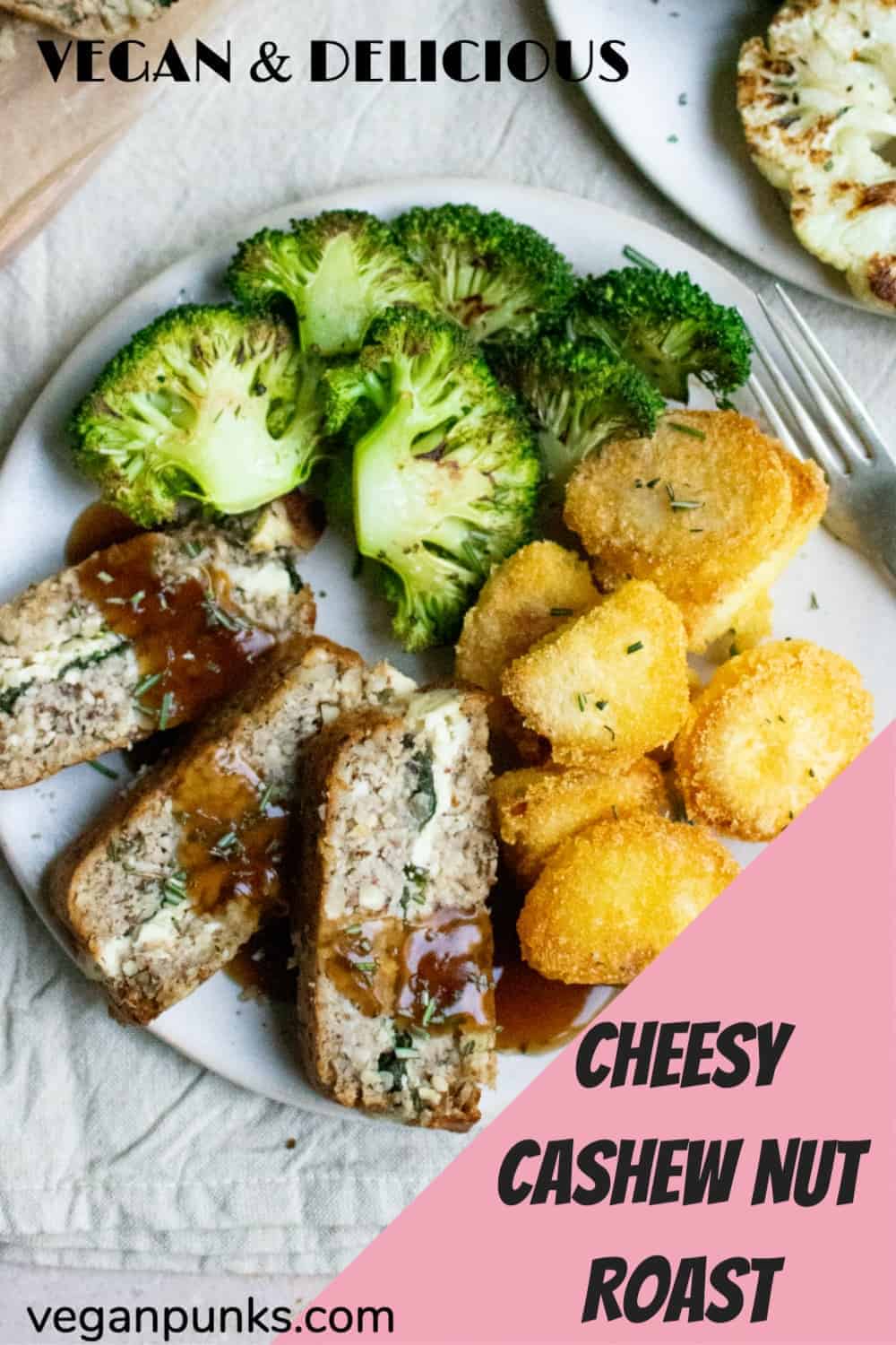 A Pinterest image titled Cheesy Cashew Nut Roast. The photo shows three slices of nut roast laying on a plate with a drizzle of gravy covering them. The slices have a cheesy spinach layer running through the middle. The plate also has roast potatoes and broccoli on it.