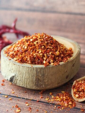 Chili flakes in a wooden bowl.