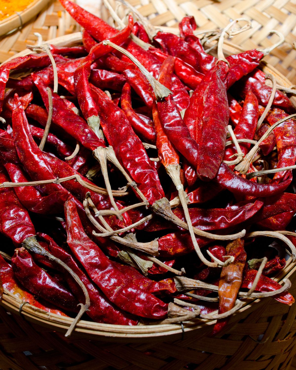 Dried chilies in a wooden basket.