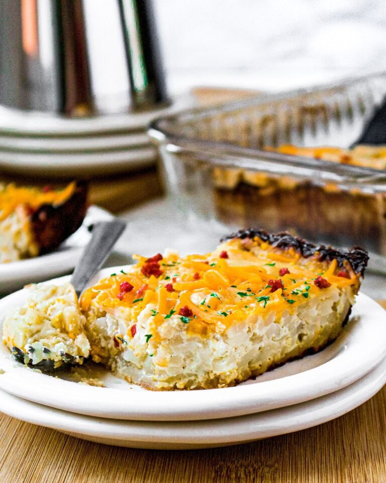 Hash brown casserole on a plate with a fork.