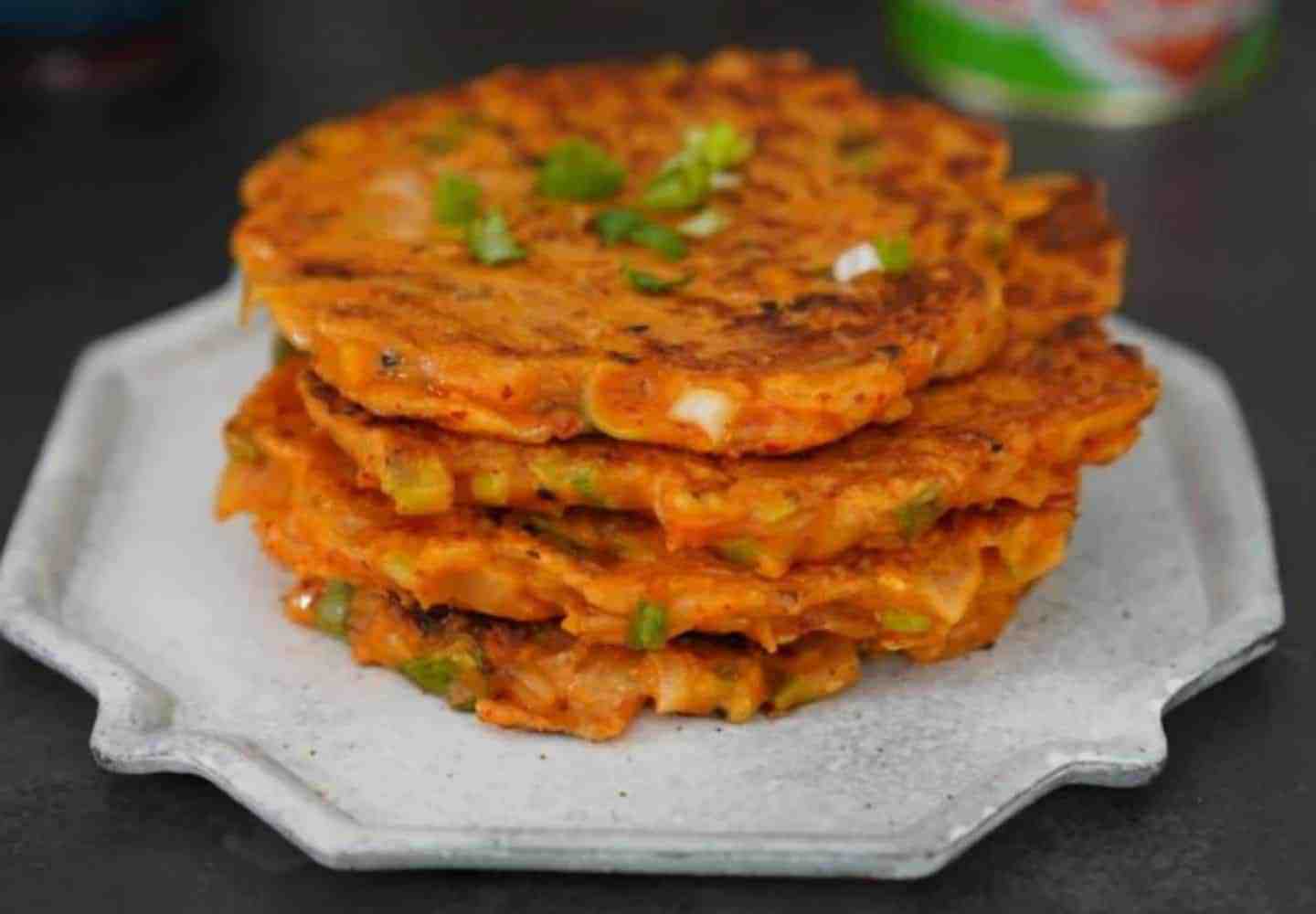 A plate stacked with four vegan kimchi pancakes