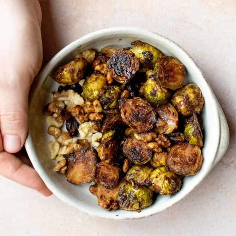 A bowl of roasted sprouts and walnuts.