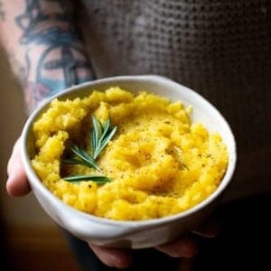 A bowl of swede mash being held