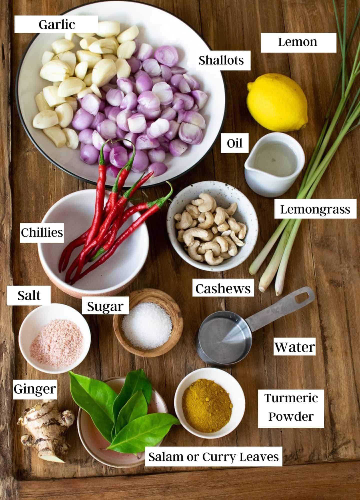 Ingredients for Balinese spice paste laid out on a table with a label for each ingredient