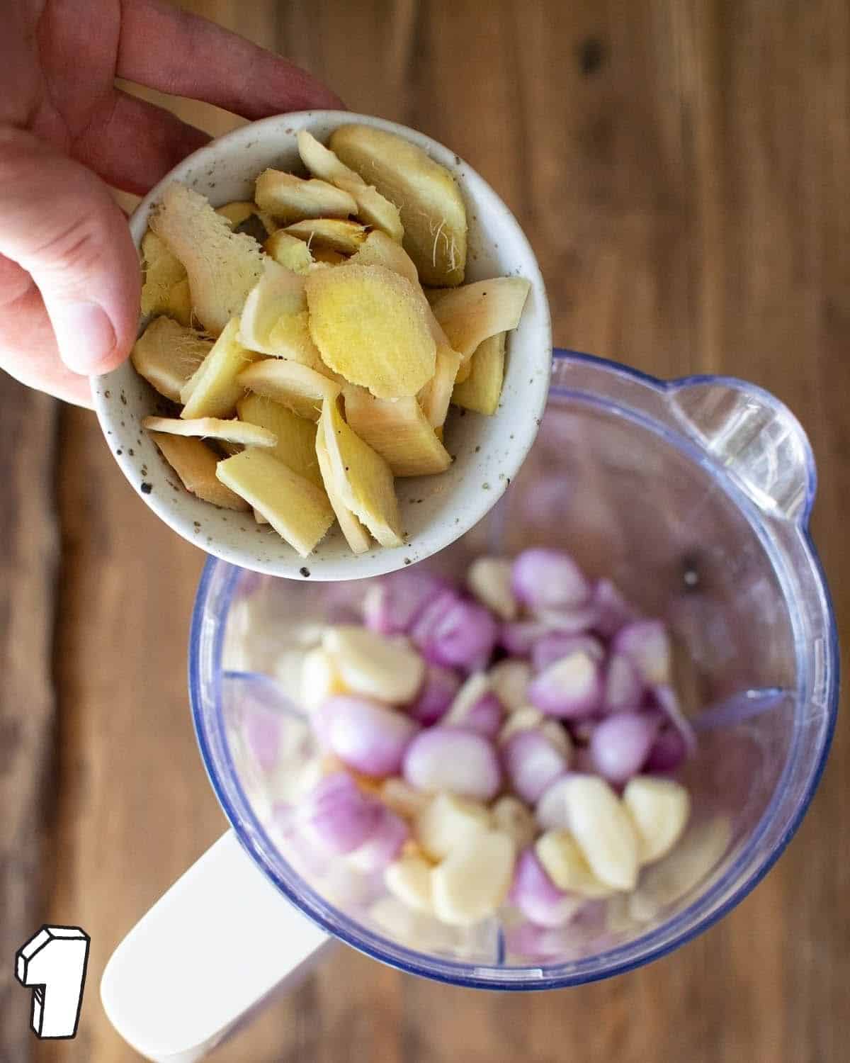 Ginger in a pot being held over a blender jug