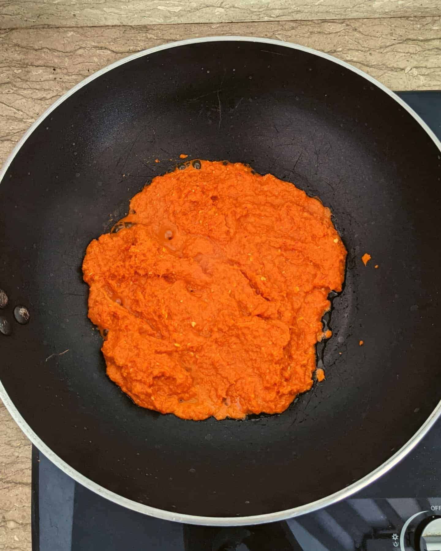 Red curry paste in a black wok 