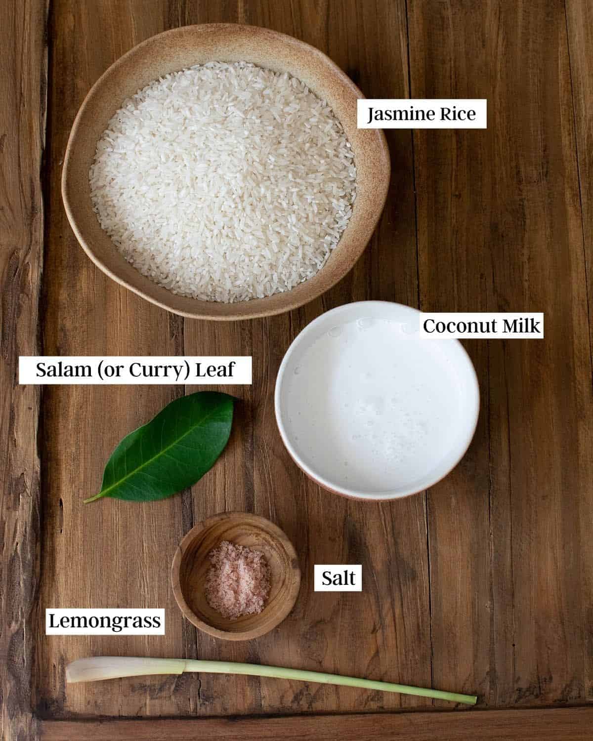 Ingredients for this recipe showing rice, coconut milk, a salam leaf, salt and lemongrass