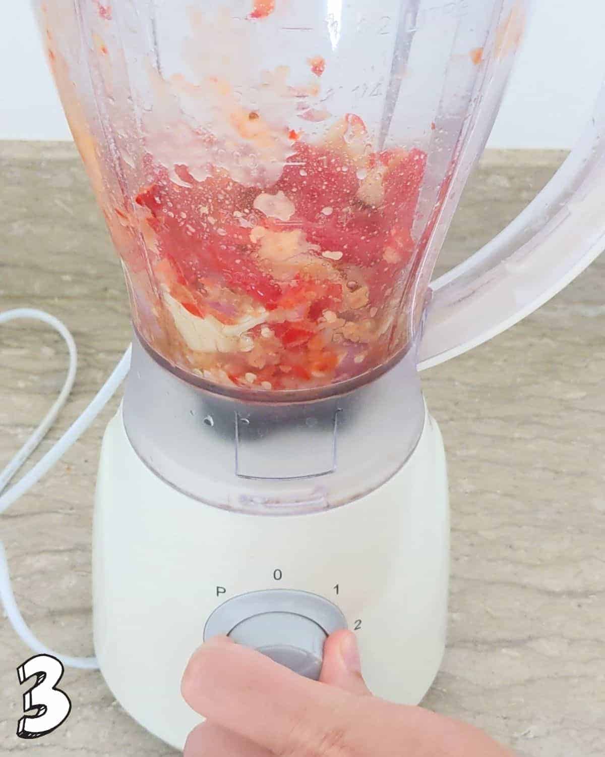 Close up of all ingredients being blended in a blender jug