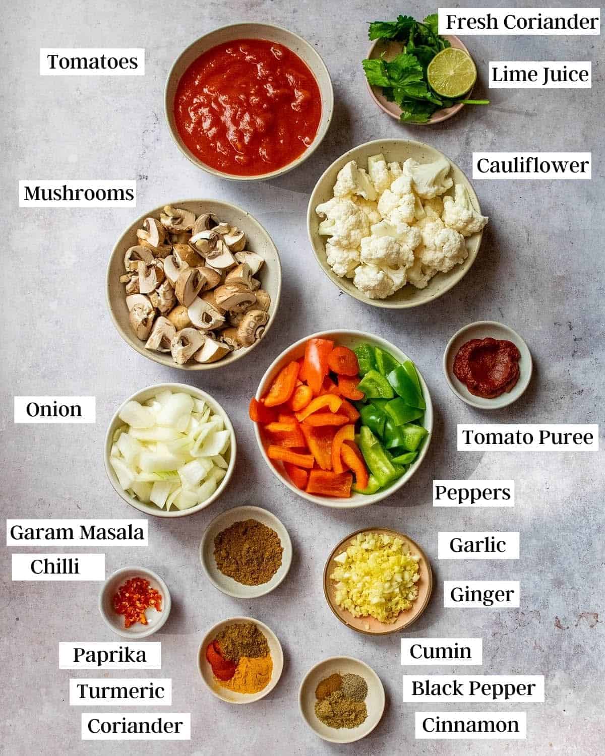 Chopped ingredients and spices in separate bowls on a table