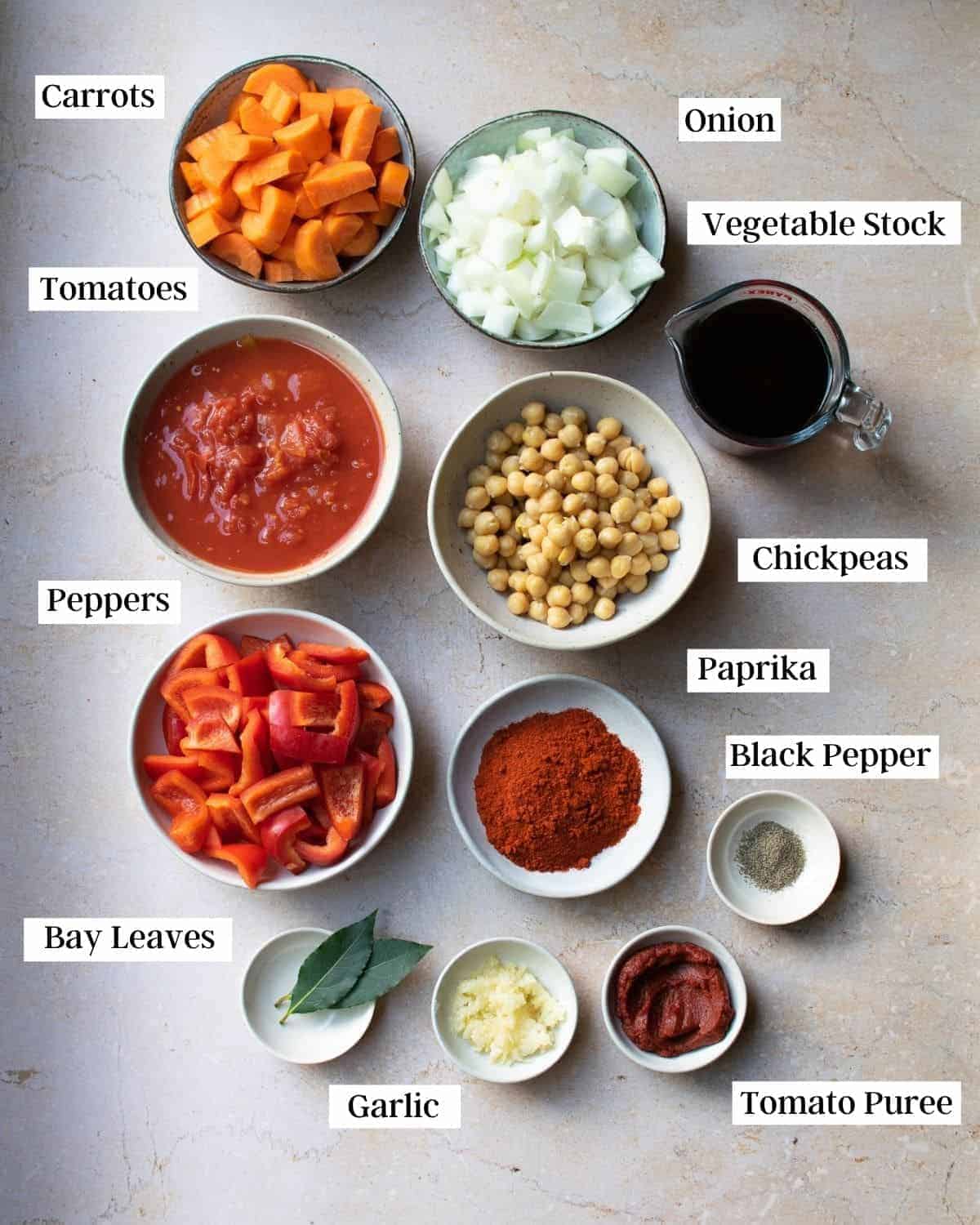 Ingredients for vegan goulash laid out in small bowls on a work surface