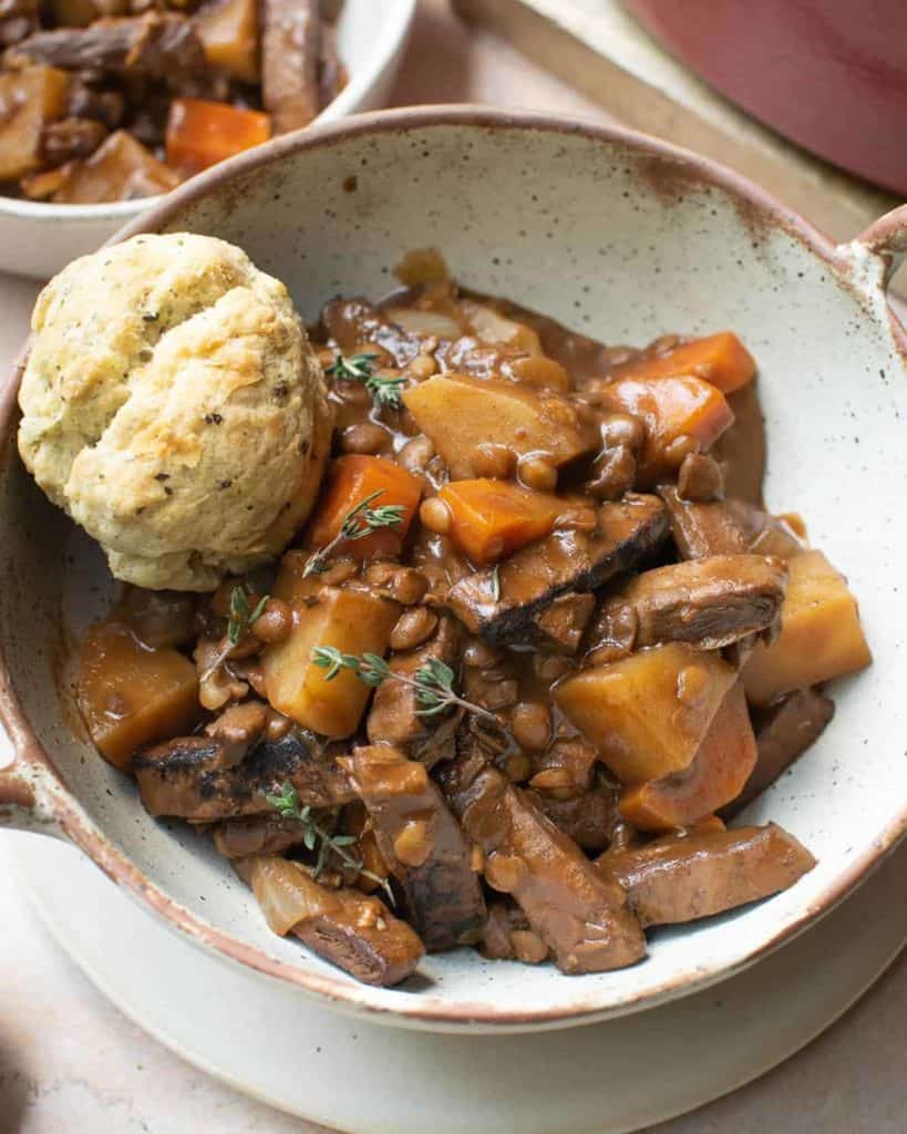 Close up of vegan beef stew in a bowl with a dumpling