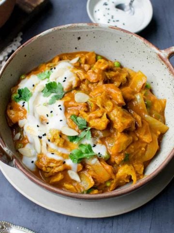 Square image of seitan curry topped with coconut yoghurt