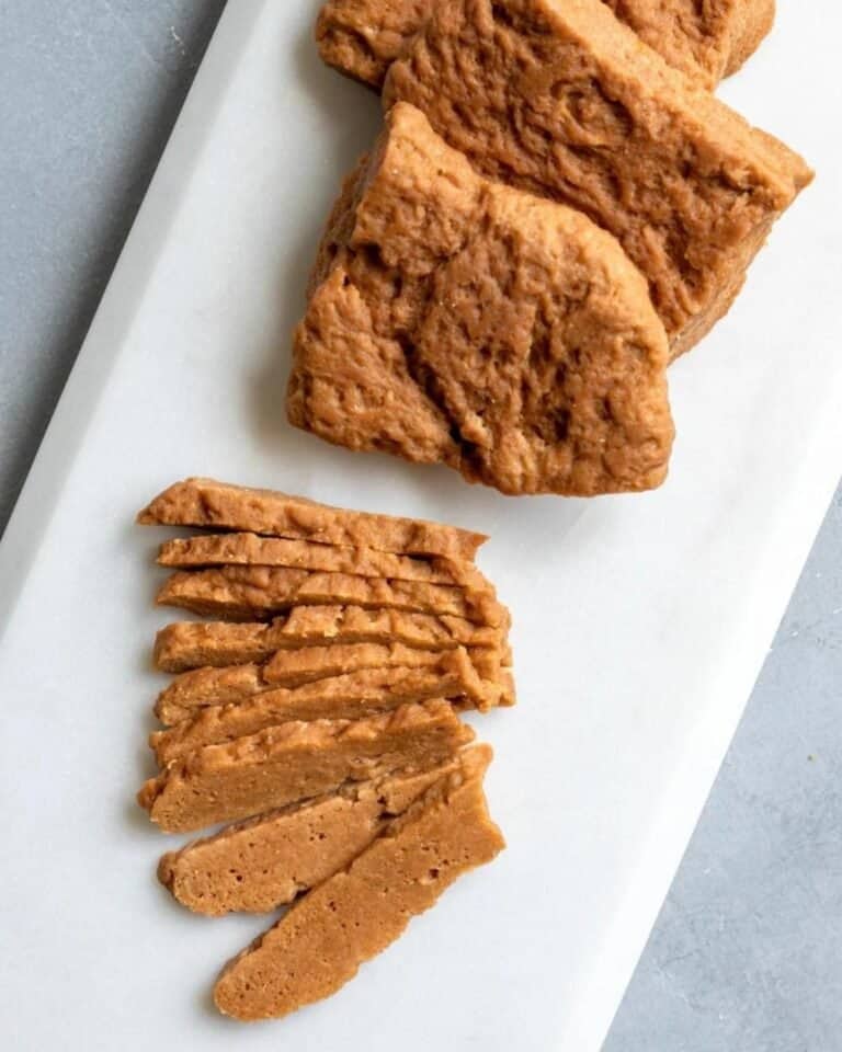 Slices of seasoned seitan on a plate.