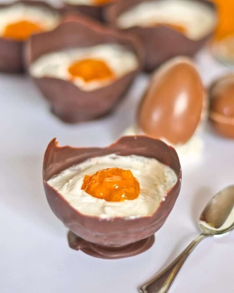 Vegan easter dessert that looks like an egg in a chocolate cup holder.