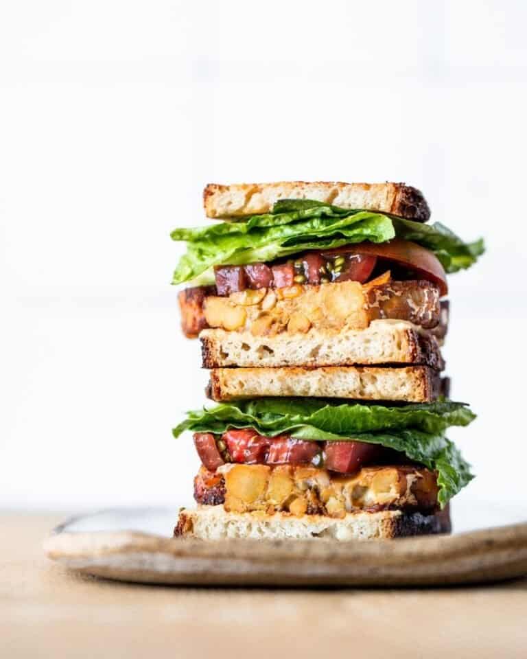 Two halves of a tempeh BLT stacked on each other.