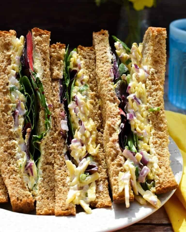 Vegan cheese and onion sandwiches on a plate.