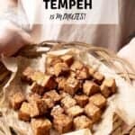 Air fryer tempeh in a basket with a Pinterest title above.