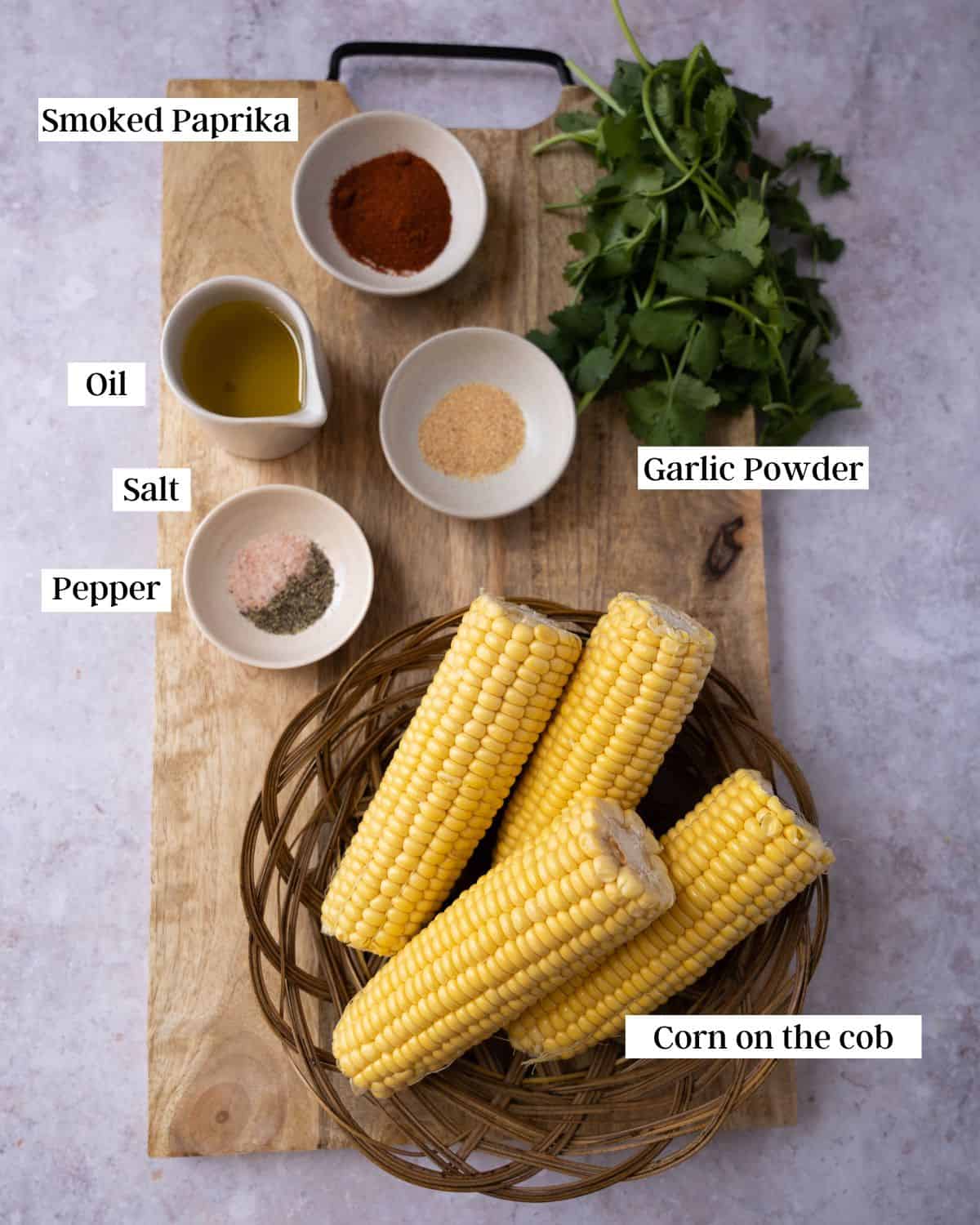 Ingredients for corn ribs on a cutting board.