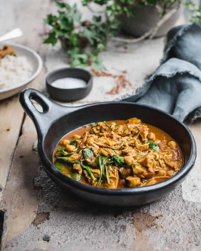 Oyster mushroom curry in a bowl with a handle.