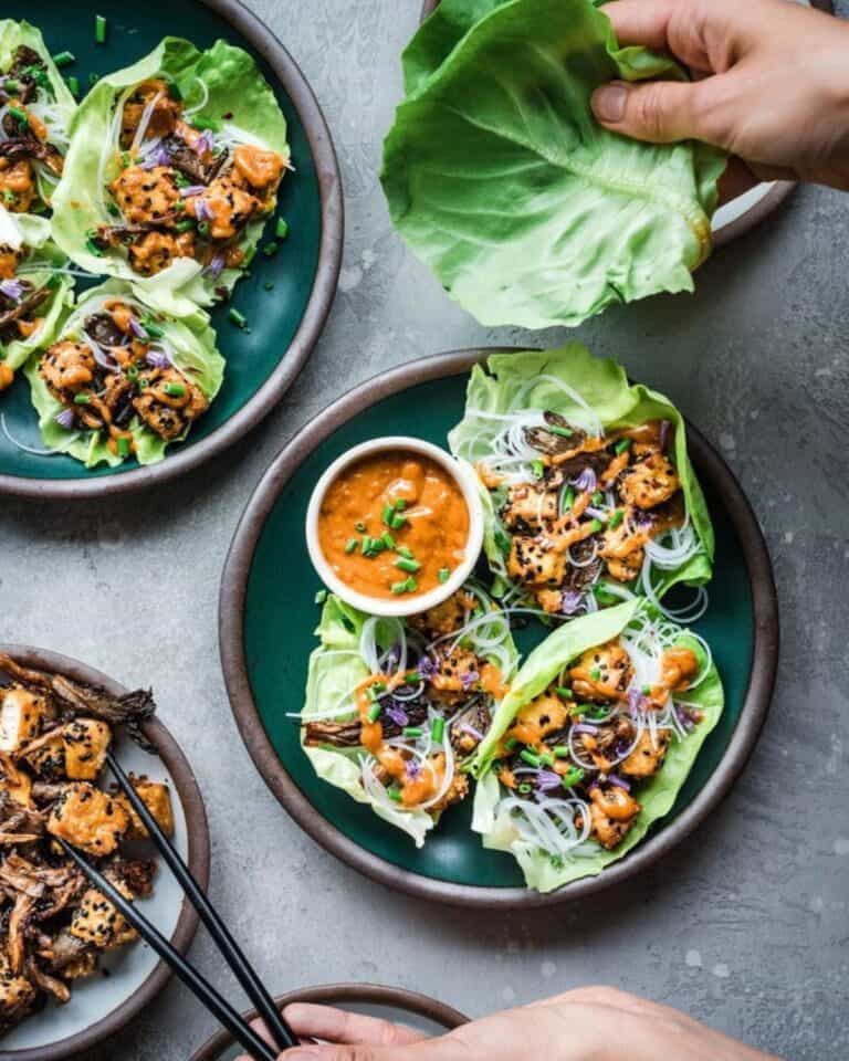 Oyster mushroom lettuce cups with peanut sauce on a plate.