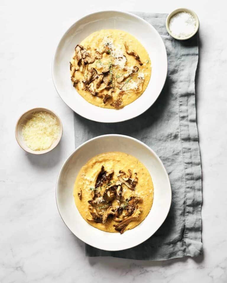 Two bowls of polenta with oyster mushrooms.