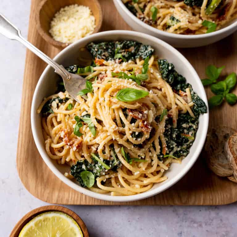 Cavolo nero pasta in a bowl with fresh basil.
