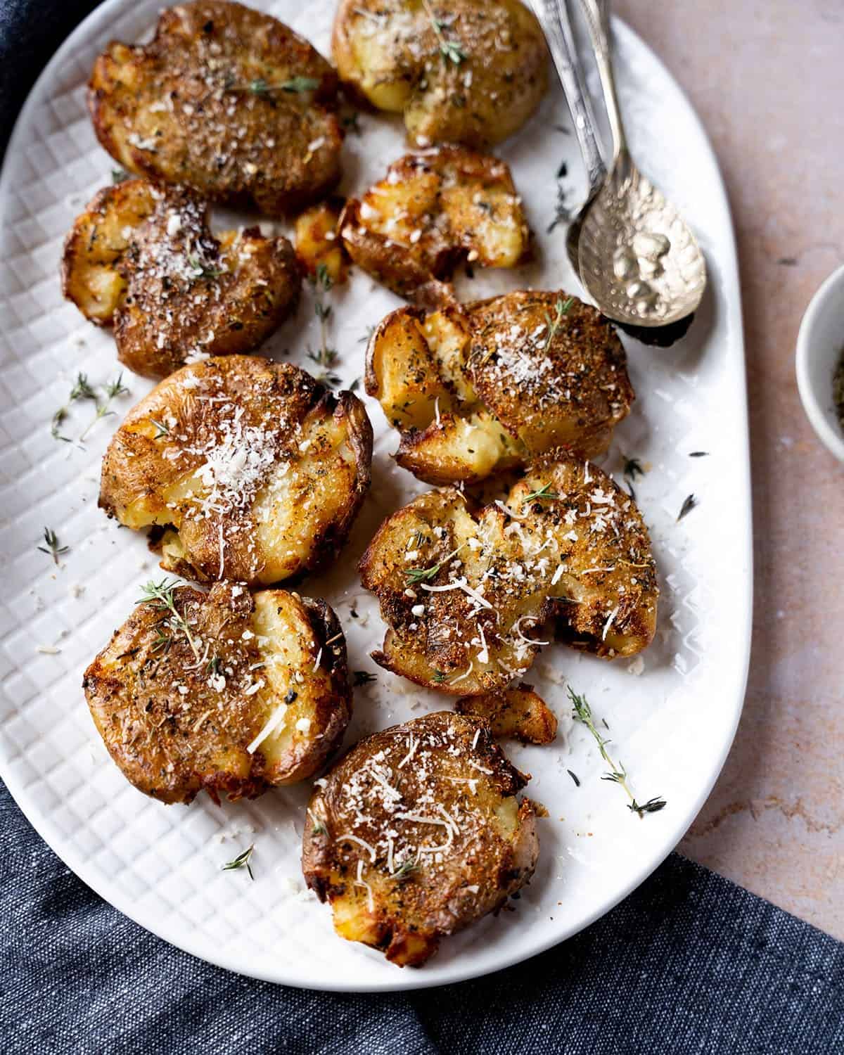 A plate full with crispy air fryer smashed potatoes.