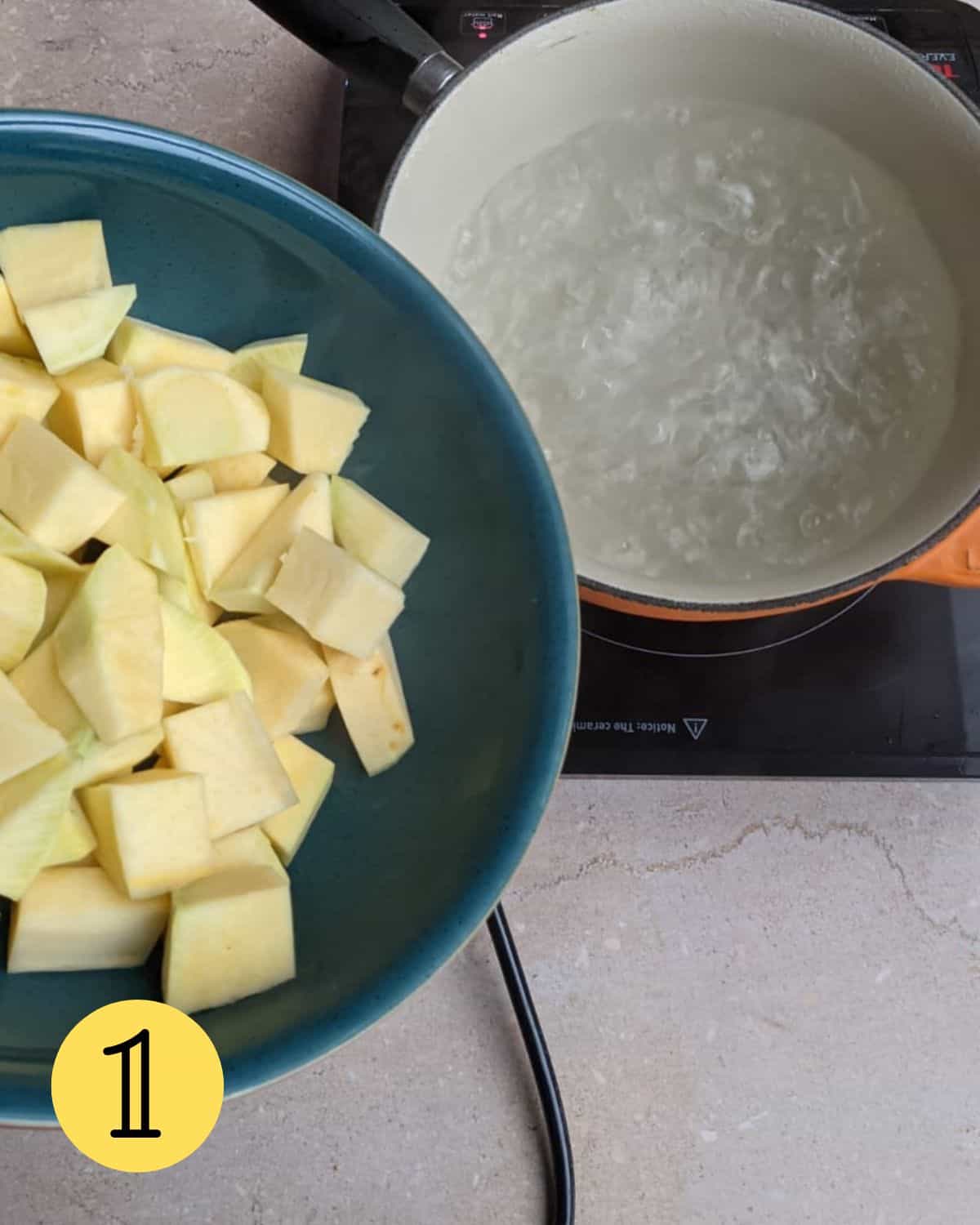 Chopped swede in a bowl above a pan of hot water.