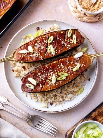 Miso aubergine on a bed of rice topped with sesame seeds and spring onions.