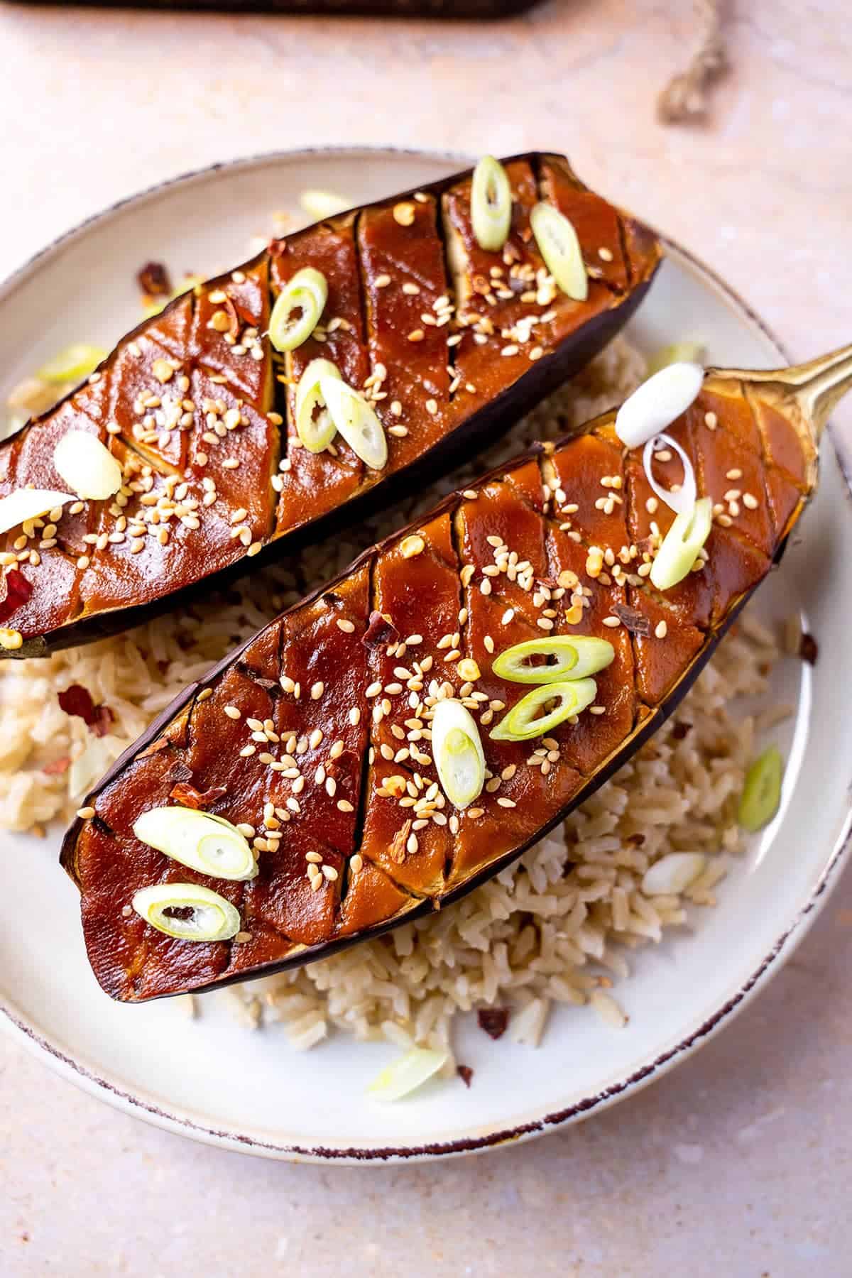 Close up of miso aubergine topped with sesame seeds and slices of spring onion.