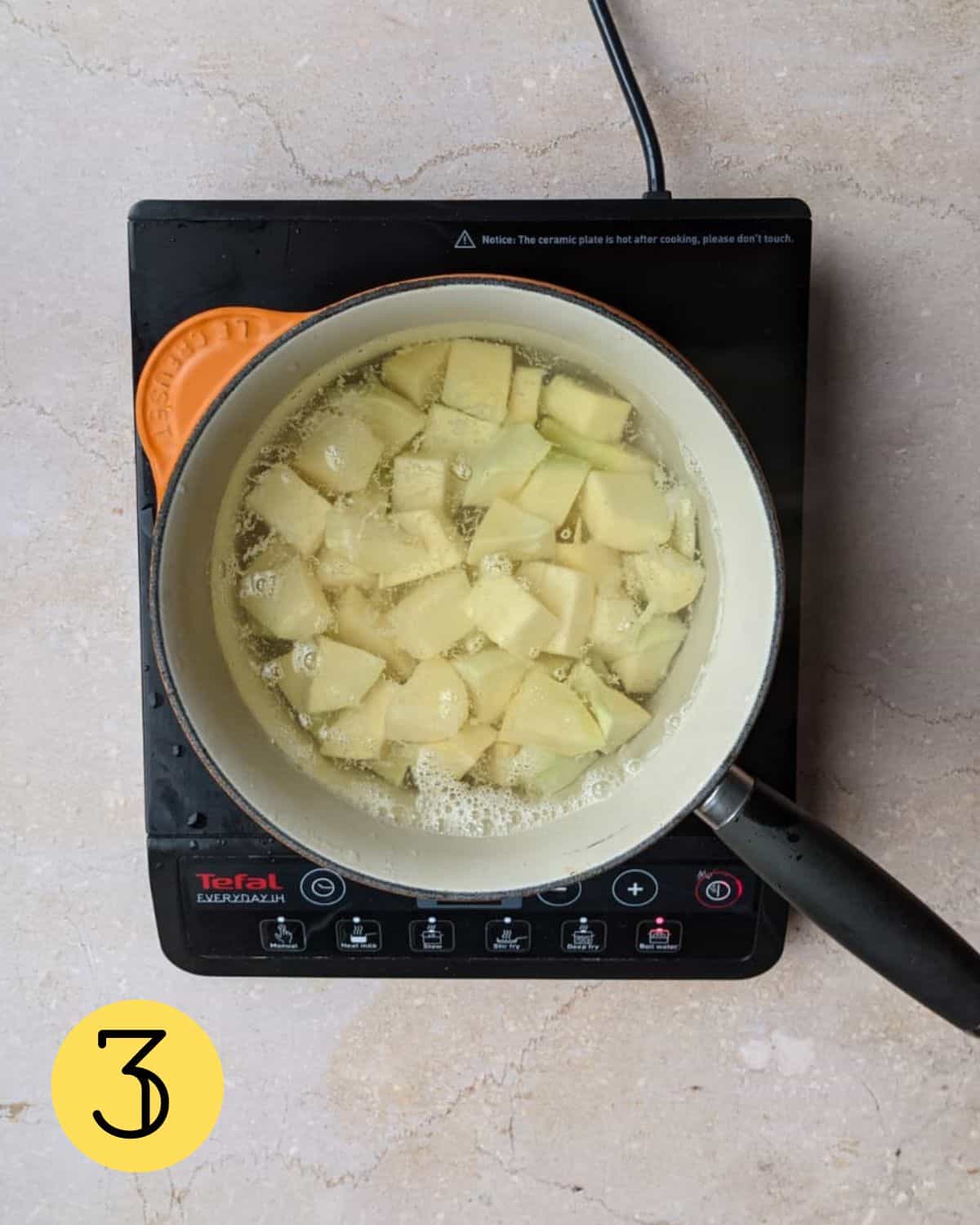 Chopped swede in a pan of boiling water.