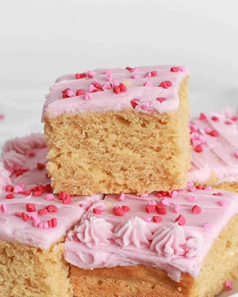 Slabs of Valentine's cake with pink icing and sprinkles.